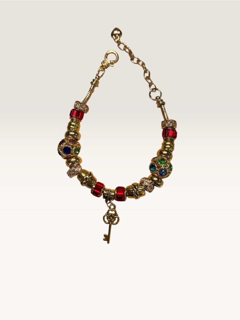 Handmade Gold Beaded Bracelet with Red Accents and Key Charm